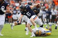 Calijah Kancey #8 of the Pittsburgh Panthers trips up Brennan Armstrong #5 of the Virginia Cavaliers